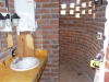 The bathroom sink and the shower around the corner, notice the sweet Bosch on demand water heater