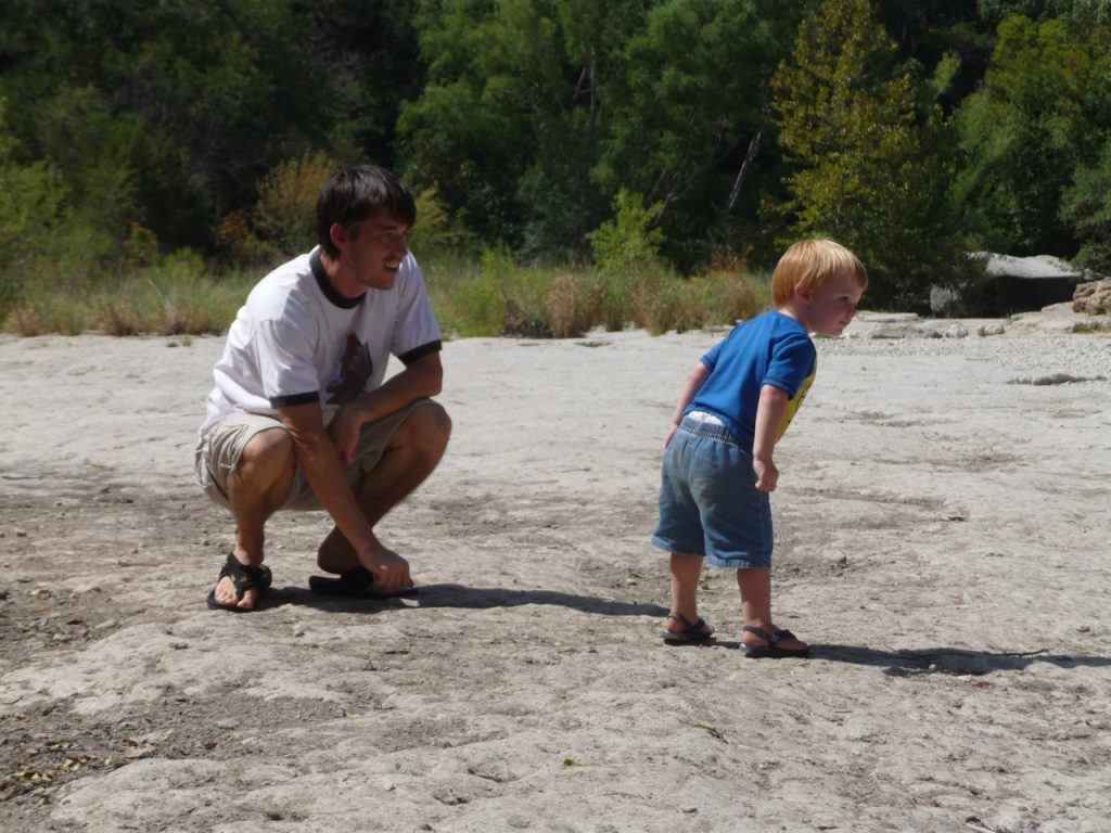 Kevin and Holden deciding where to throw the next rock