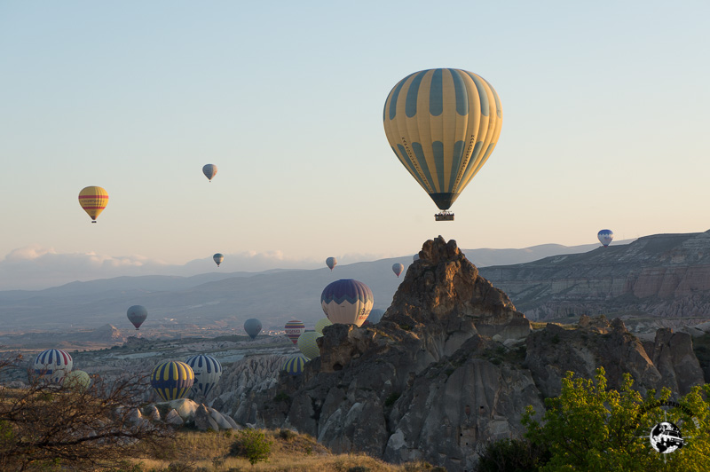 Hot air balloons rising out of the valley in Capadocia, Turkey.